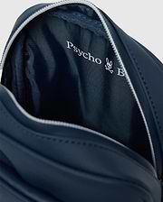 Classic Bunny Messenger Bag in navy blue, featuring a smooth exterior, white zipper, and a textured interior lining with a prominent white Psycho Bunny logo.