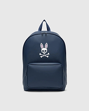 Classic Bunny Backpack in navy blue with a smooth matte finish, featuring a large white and pink Psycho Bunny skull logo centered on the front and a zippered front pocket.