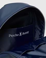 Classic Bunny Backpack in navy blue, featuring a smooth exterior, light grey zipper, and a large white Psycho Bunny skull logo printed on the interior pocket with multiple compartments.
