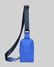 Vibrant blue Rubberized Crossbody Bag featuring a large, tonal embossed Psycho Bunny skull logo on the front. Includes a dark navy adjustable strap with debossed Psycho Bunny branding.
