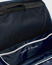 Classic Bunny Gym Bag interior featuring a navy blue lining, black mesh zippered pocket, white piping, and a prominent white Psycho Bunny skull logo print.