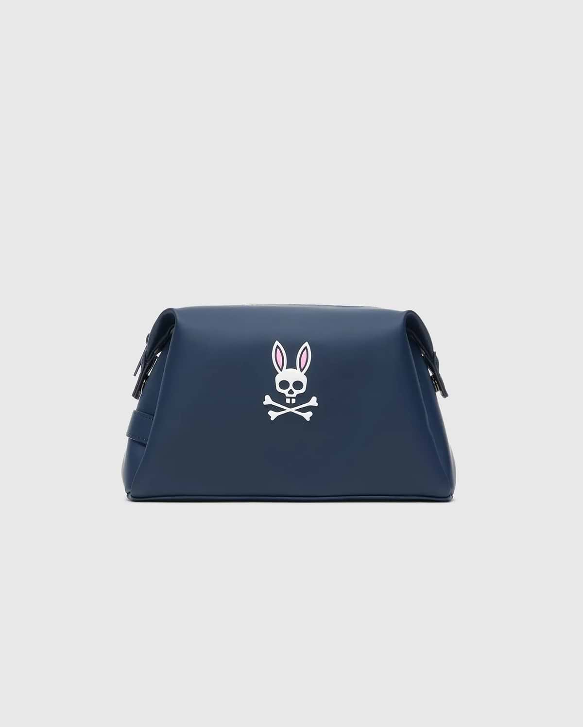 Classic Bunny Toiletry Kit in navy blue with a smooth texture, featuring a prominent white and pink Psycho Bunny skull logo centered on the front.