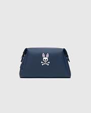 Classic Bunny Toiletry Kit in navy blue with a smooth texture, featuring a prominent white and pink Psycho Bunny skull logo centered on the front.