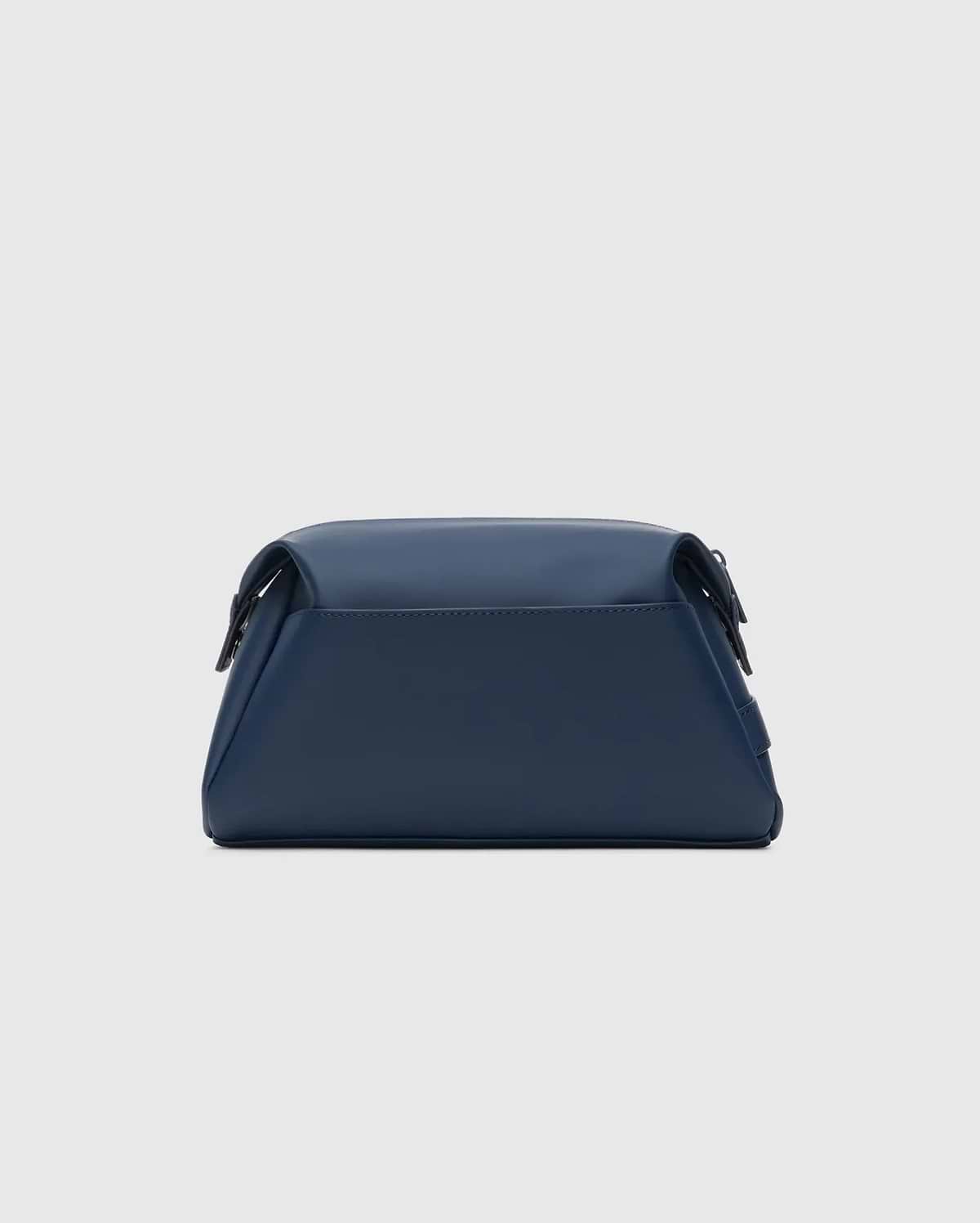 Classic Bunny Toiletry Kit, a sleek navy blue travel pouch crafted from smooth, matte faux leather, featuring a structured rectangular design with soft edges and subtle dark hardware.