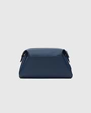 Classic Bunny Toiletry Kit, a sleek navy blue travel pouch crafted from smooth, matte faux leather, featuring a structured rectangular design with soft edges and subtle dark hardware.
