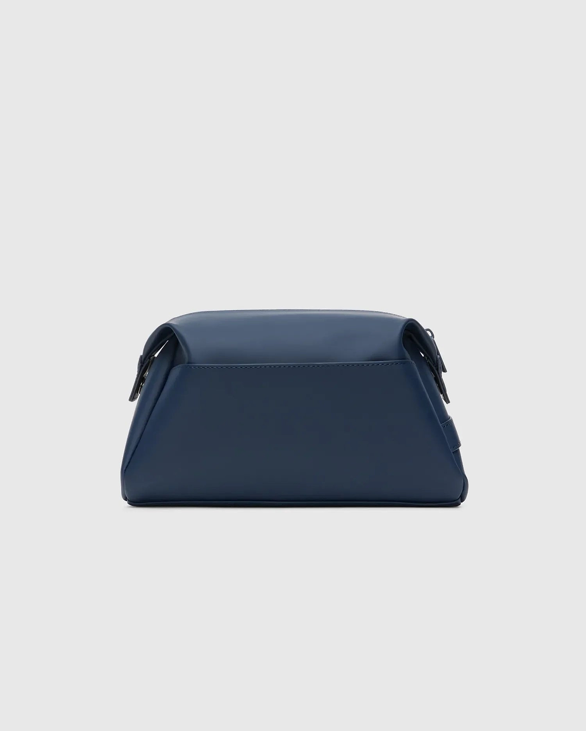 Classic Bunny Toiletry Kit, a sleek navy blue travel pouch crafted from smooth, matte faux leather, featuring a structured rectangular design with soft edges and subtle dark hardware.