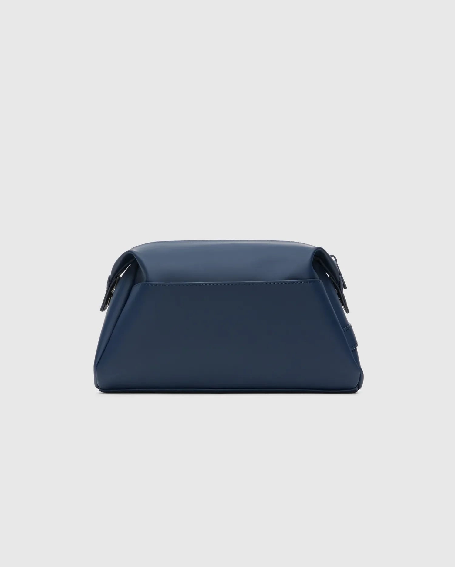 Classic Bunny Toiletry Kit, a sleek navy blue travel pouch crafted from smooth, matte faux leather, featuring a structured rectangular design with soft edges and subtle dark hardware.