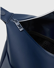 Classic Bunny Toiletry Kit in deep navy blue, featuring a smooth, matte synthetic exterior, white zipper teeth, a custom dark grey Psycho Bunny skull logo zipper pull, and an interior mesh pocket.