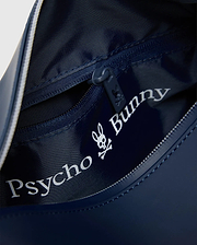 Classic Bunny Toiletry Kit in navy blue, with textured interior lining, zippered main compartment, and large white Psycho Bunny skull logo print inside, plus a small bunny skull on the zipper pull.