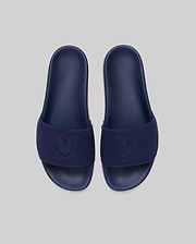 Mens Contrast Sole Knit Slides in navy with a subtle pink contrast sole, featuring a knitted strap with a woven Psycho Bunny skull logo. (3)