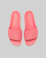 Mens Knit Slides in vibrant coral pink, featuring a textured knit strap with a prominent debossed Psycho Bunny skull logo, and a matching textured rubber sole for comfort. (3)
