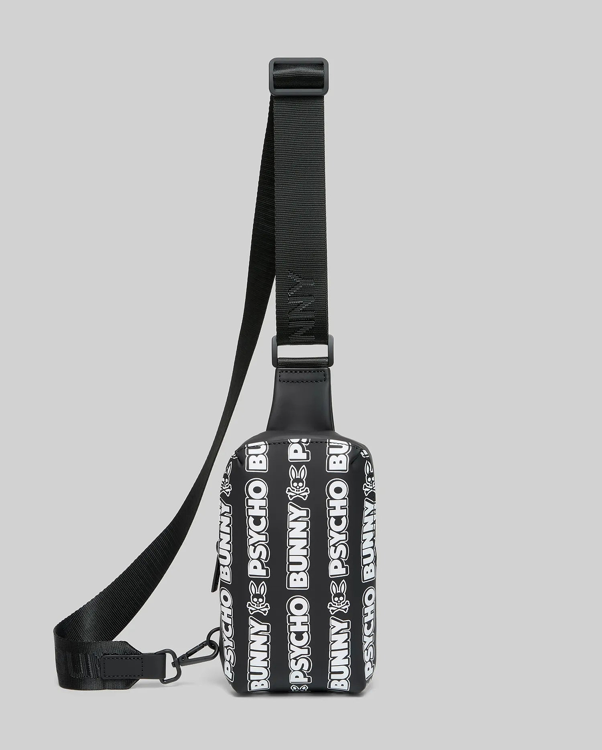 Mens Rubberized Crossbody bag featuring an all-over white repeating Psycho Bunny text and skull logo pattern on a black rubberized body with a black woven adjustable strap.