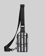 Mens Rubberized Crossbody bag featuring an all-over white repeating Psycho Bunny text and skull logo pattern on a black rubberized body with a black woven adjustable strap.
