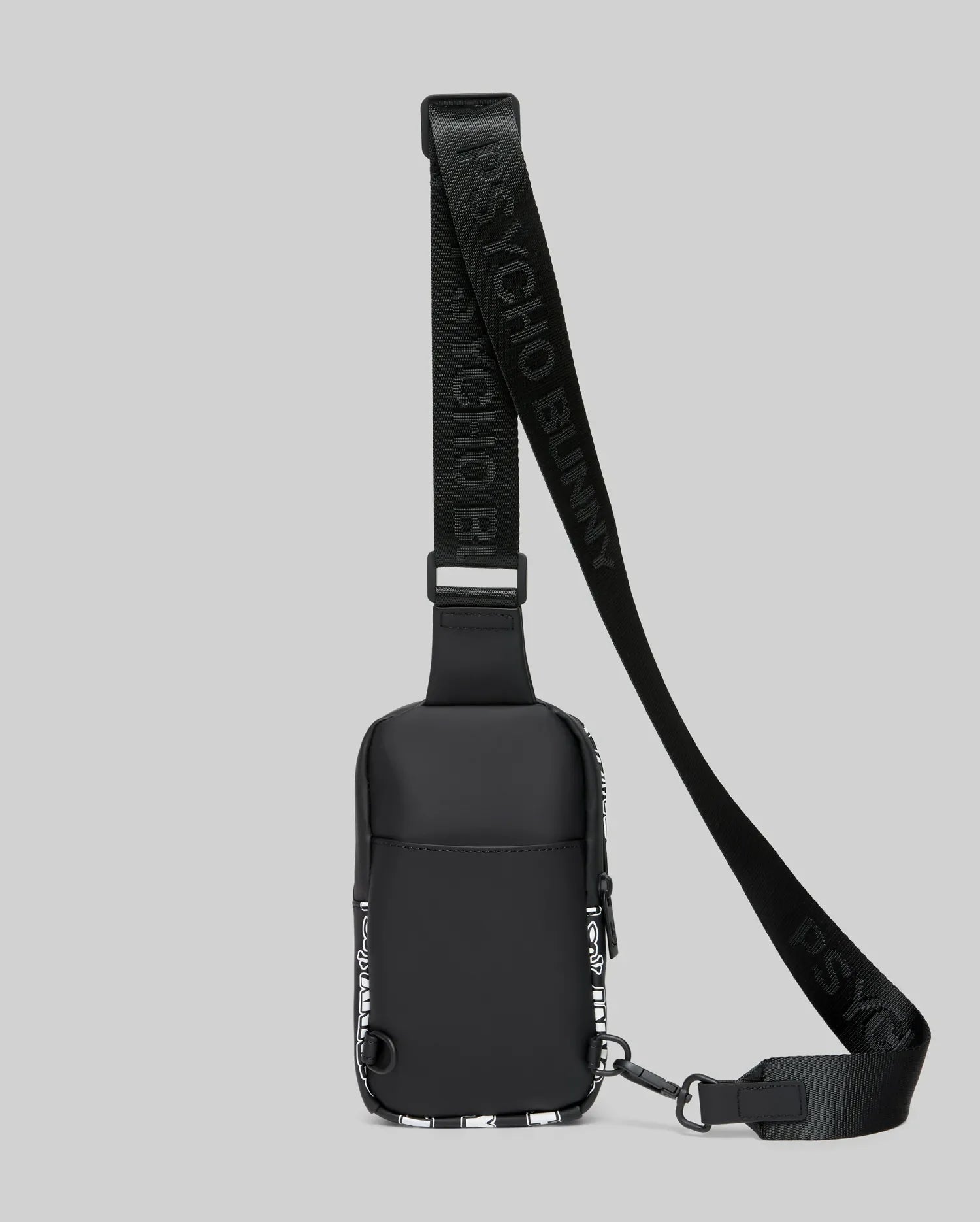 Mens Rubberized Crossbody bag in black, featuring a sleek rubberized finish, white abstract side panel pattern, and a black webbing strap with repeating Psycho Bunny text branding.