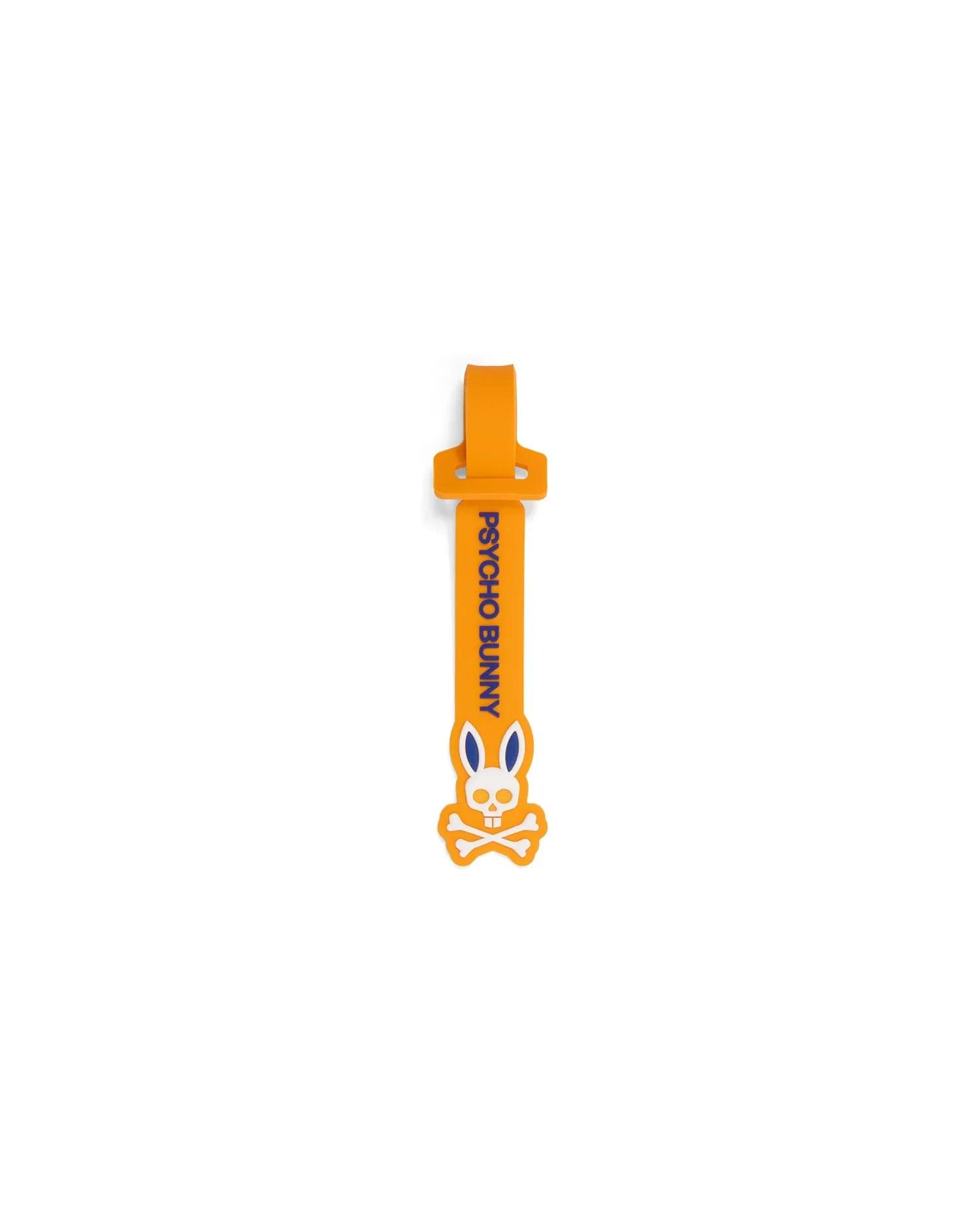 Mens Silicone Strap Luggage Tag in vibrant orange, showcasing bold vertical blue Psycho Bunny text and a prominent white and blue bunny skull logo design. (1)