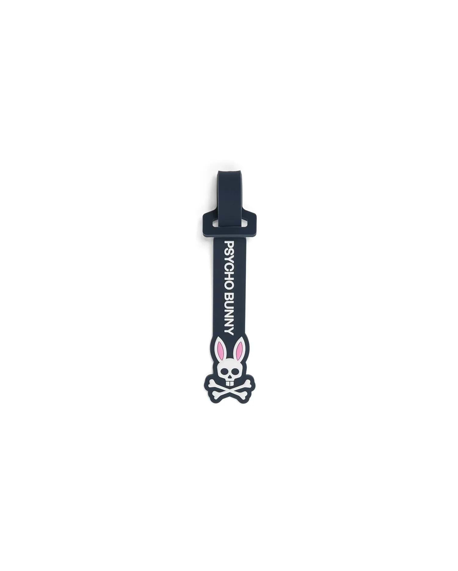 Mens Silicone Strap Luggage Tag, a sleek dark navy blue silicone strap featuring prominent vertical white PSYCHO BUNNY text and a large, detailed white and pink bunny skull logo.