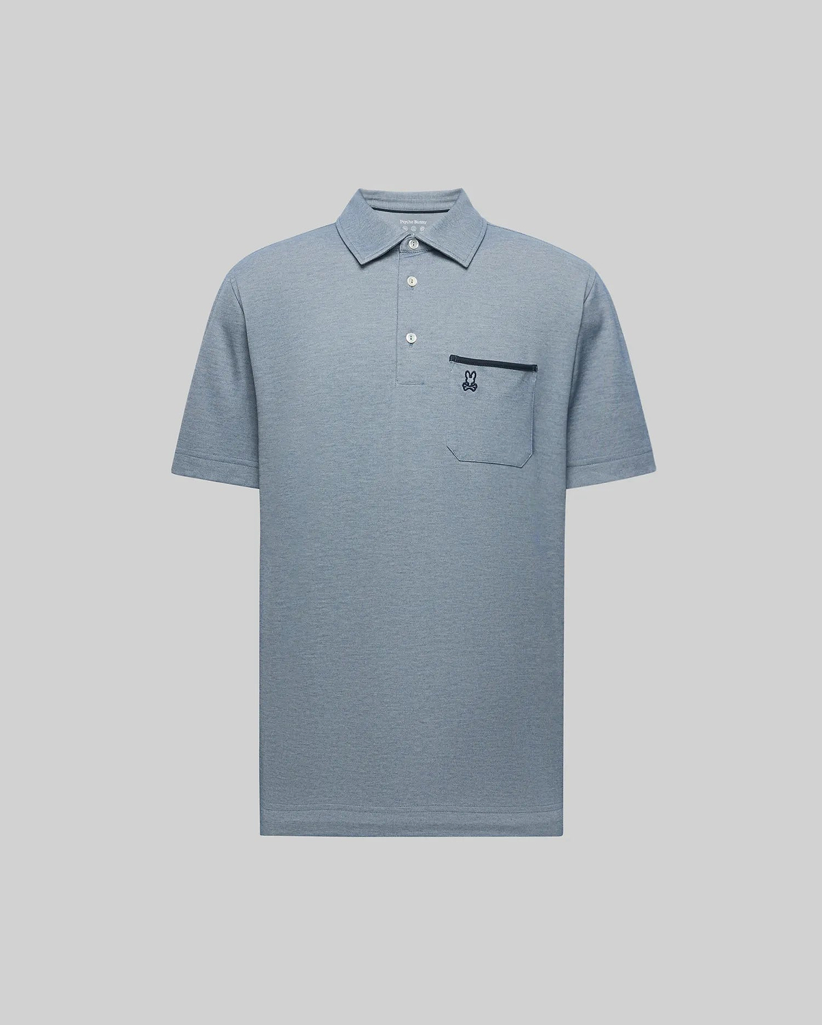 The Psycho Bunny MENS HADLEY PERFORMANCE PIQUE POLO (MT0100021) is a light blue short-sleeve collared shirt with three buttons and a chest pocket featuring an embroidered dark blue bunny logo, shown on a plain light grey background. (5)