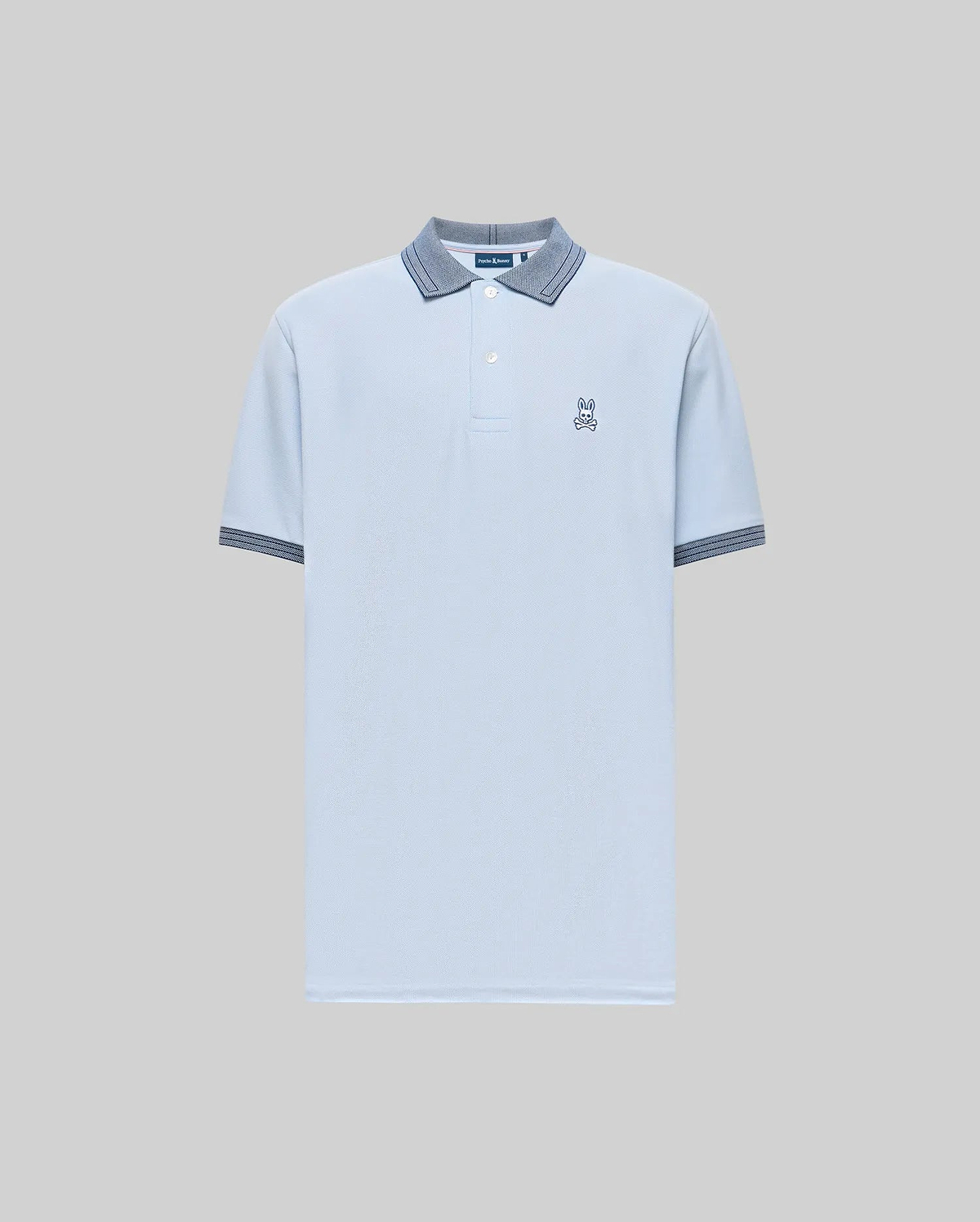 The Psycho Bunny Men's Murphy Pique Polo Shirt (MT0100026) is light blue, crafted from soft Pima cotton, with a buttoned collar, dark blue striped trim on the collar and cuffs, and a small embroidered Bunny logo on the chest. Plain gray background. (5)
