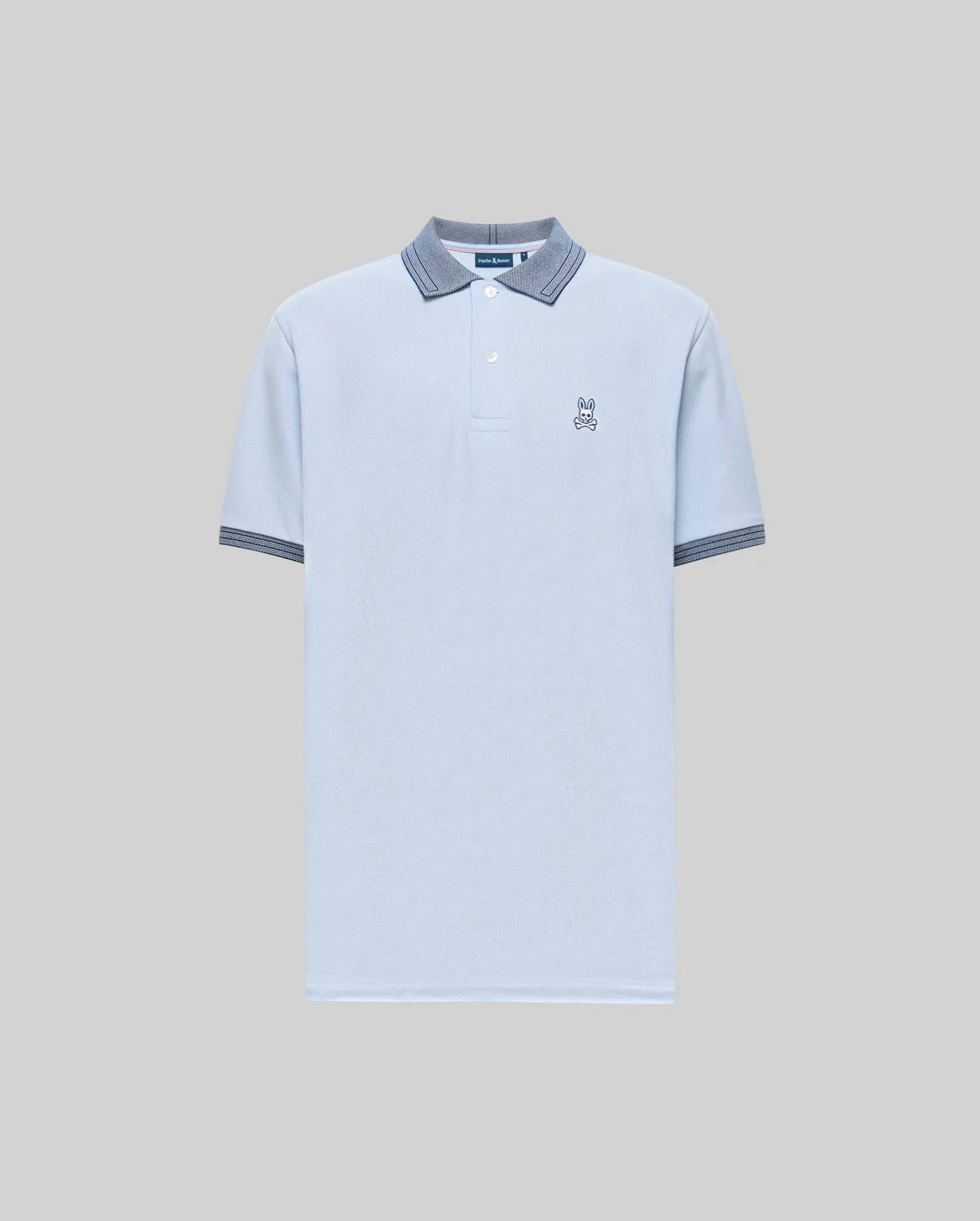 The Psycho Bunny Men's Murphy Pique Polo Shirt (MT0100026) is light blue, crafted from soft Pima cotton, with a buttoned collar, dark blue striped trim on the collar and cuffs, and a small embroidered Bunny logo on the chest. Plain gray background. (5)