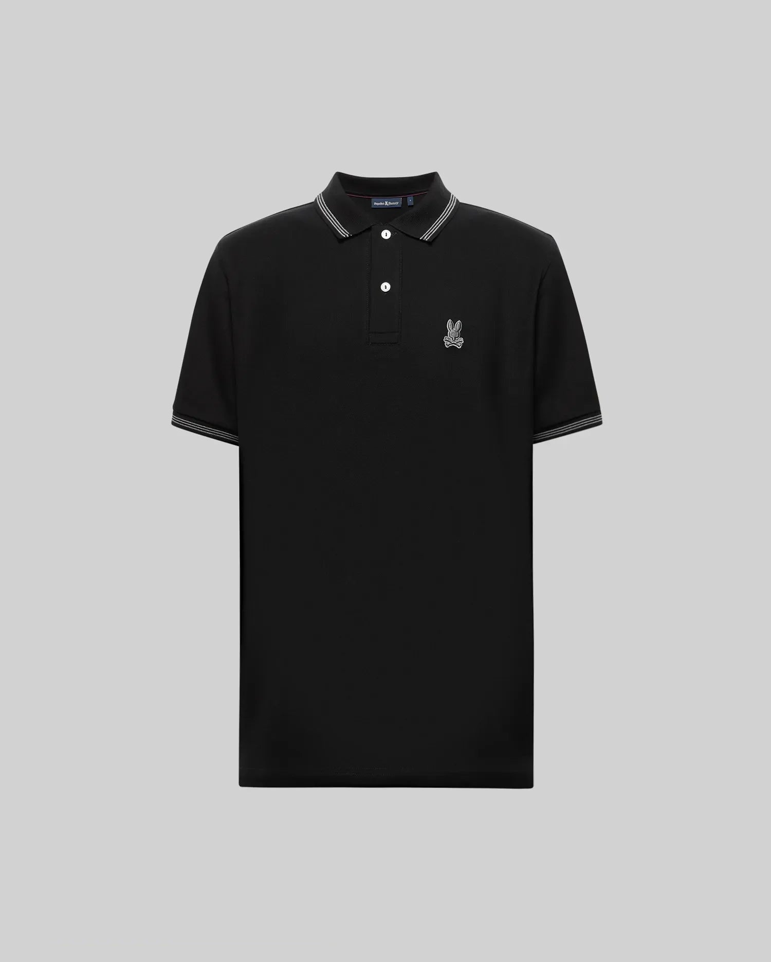 The Psycho Bunny MENS HART PIQUE POLO SHIRT (MT0100032) is a black short-sleeve Pima cotton polo with white-trimmed collar and sleeves, button placket, and an embroidered cartoon rabbit logo on the left chest. Shown on a gray background. (5)