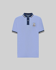 The Psycho Bunny MENS WADE PIQUE POLO (MT0100044) features light blue Pima cotton, a navy collar, white buttons, signature bunny patch on the chest, and navy & white colorblock tipped cuffs. Shown on a plain gray background. (5)