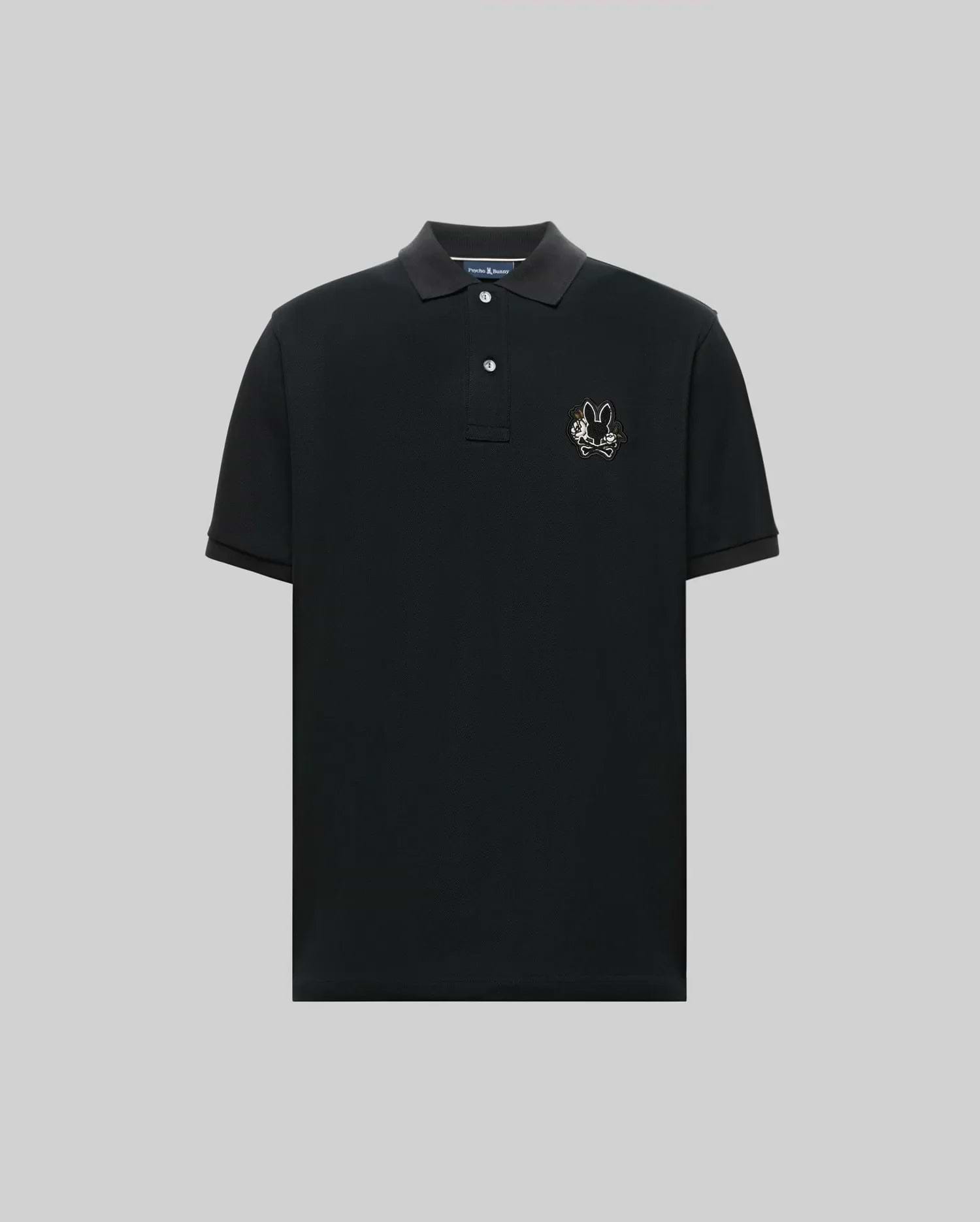 The Psycho Bunny MENS AUGUSTE PIQUE POLO SHIRT (MT0100051) is a black, short-sleeved collared polo with three buttons and an embroidered chenille bunny patch on the left chest, shown against a plain gray background. (5)