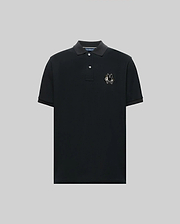The Psycho Bunny MENS AUGUSTE PIQUE POLO SHIRT (MT0100051) is a black, short-sleeved collared polo with three buttons and an embroidered chenille bunny patch on the left chest, shown against a plain gray background. (5)