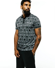 Mens Reeves All Over Bunny Sport Polo, a black and white all-over bunny skull pattern polo shirt with a classic fit, smooth performance fabric, black collar, and white striped cuffs.