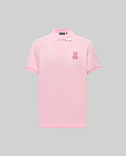 The Psycho Bunny MENS PATRICK POLO (MT0100095) is a light pink, 100% cotton knit short-sleeve shirt with a collar, button placket, and an embroidered pink bunny logo on the left chest, shown against a gray background. (4)