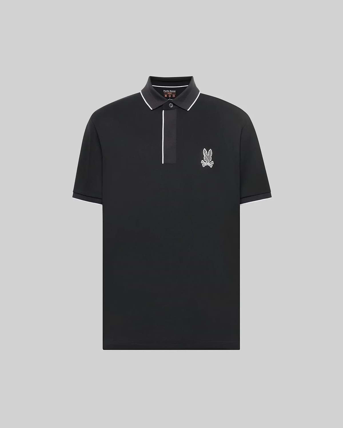 The Psycho Bunny MENS JAYDEN SPORT POLO - MT0100111 is a black, short-sleeve athletic fit polo with white trim on the collar and placket, plus a small bunny logo on the left chest. Shown against a plain light gray background.