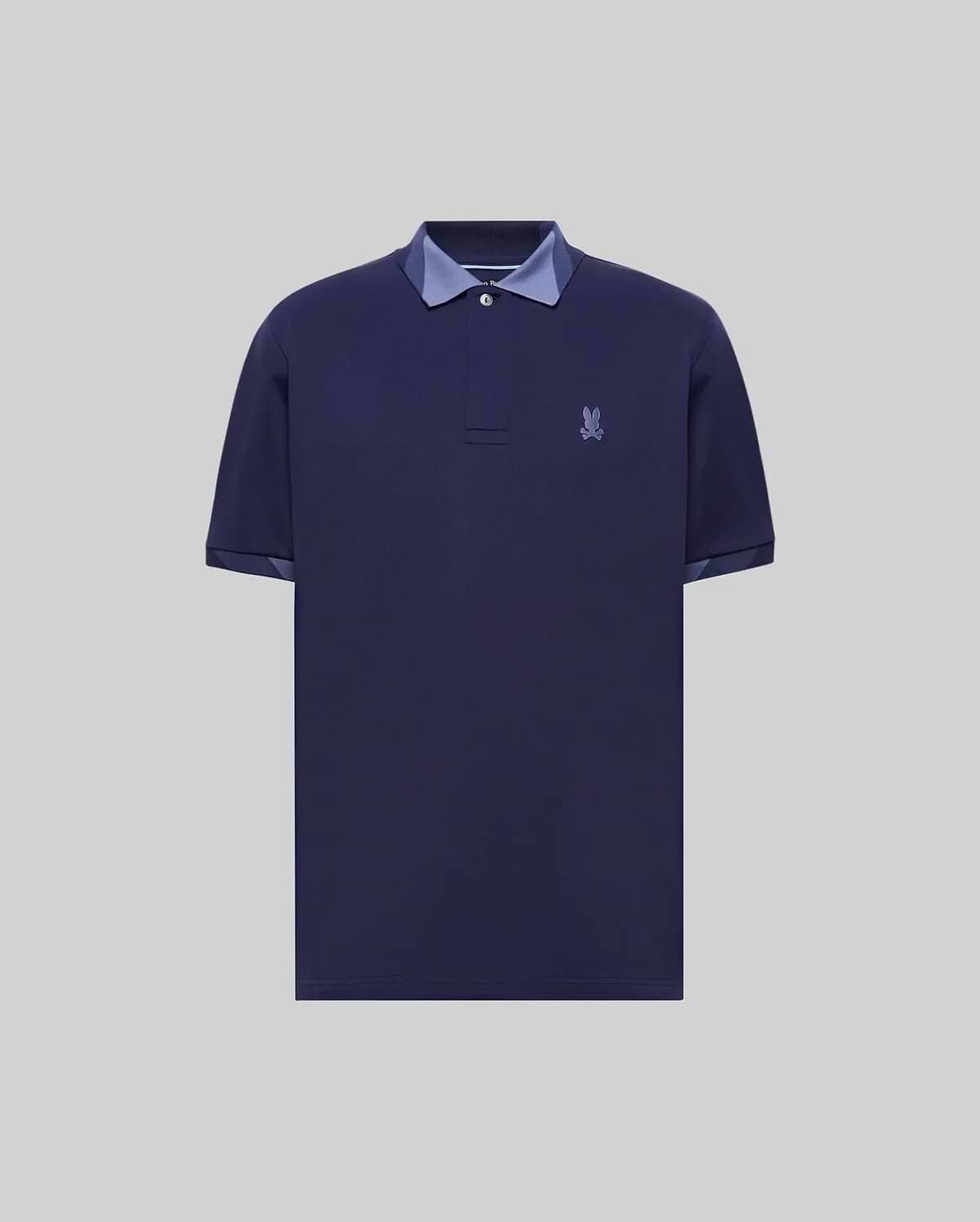Mens Onyx Sport Polo, a classic fit dark blue pique polo with two-button placket, contrasting light blue collar and cuff lining, and an embroidered Psycho Bunny skull logo on the left chest. (5)