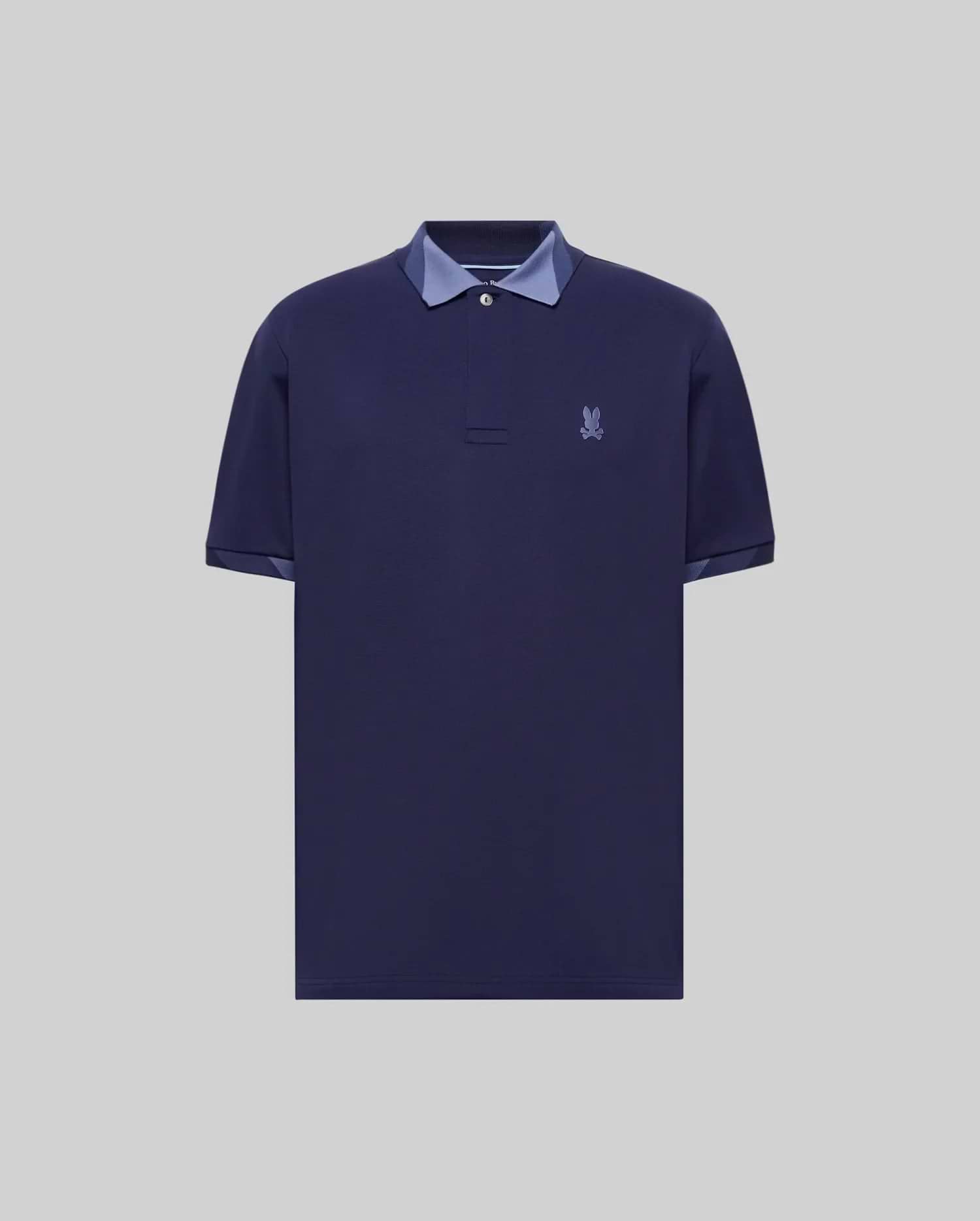 Mens Onyx Sport Polo, a classic fit dark blue pique polo with two-button placket, contrasting light blue collar and cuff lining, and an embroidered Psycho Bunny skull logo on the left chest. (5)