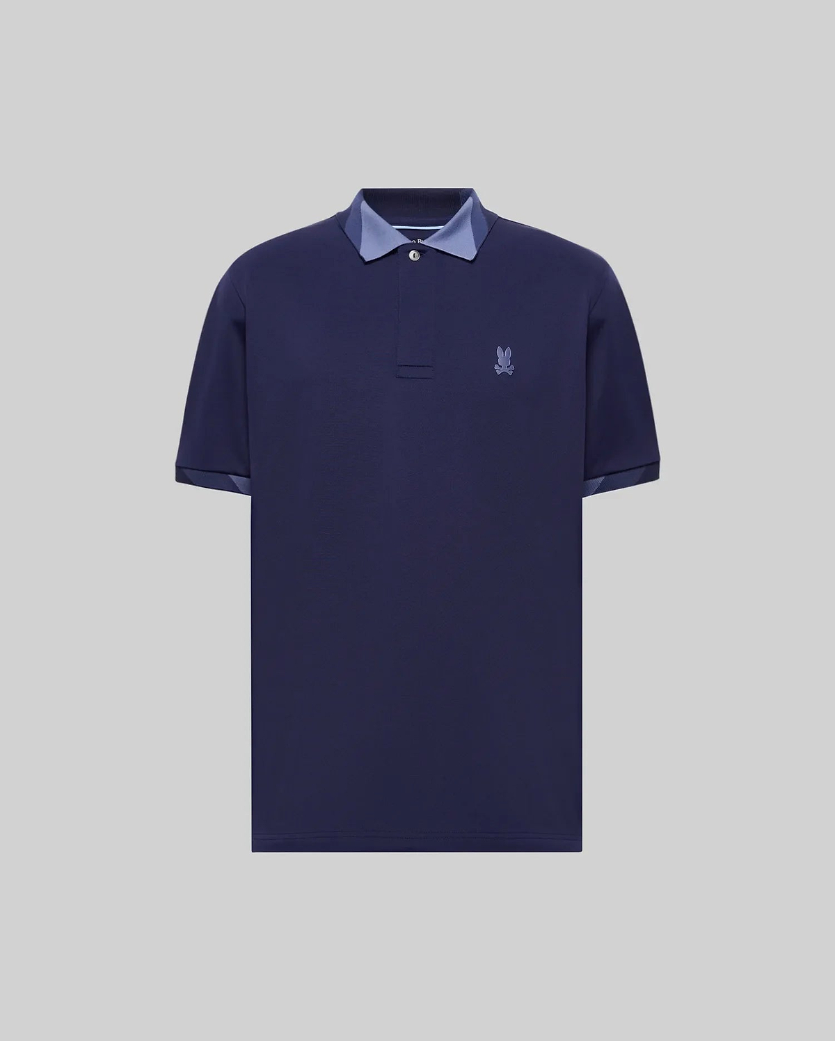 Mens Onyx Sport Polo, a classic fit dark blue pique polo with two-button placket, contrasting light blue collar and cuff lining, and an embroidered Psycho Bunny skull logo on the left chest. (5)