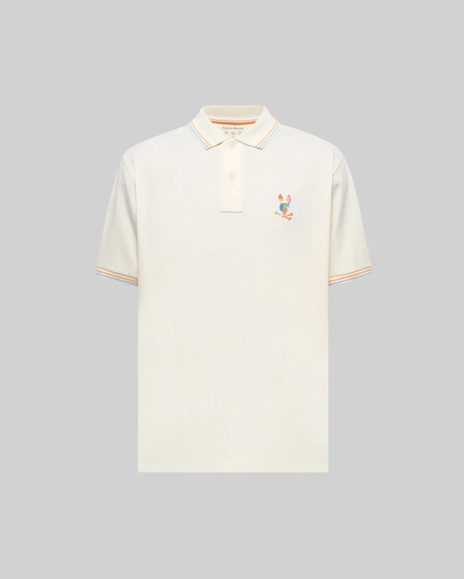 Mens Ara Pique Polo, a classic fit cream pique polo featuring a vibrant multi-color embroidered Psycho Bunny skull logo on the left chest, with orange, light blue, and white striped collar and sleeve cuffs. (4)