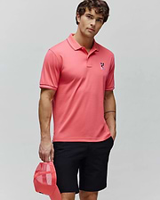 Mens Ara Pique Polo, a coral classic fit pique polo with white tipped collar and cuffs, featuring an embroidered multi-color Psycho Bunny skull logo on the left chest. (3)