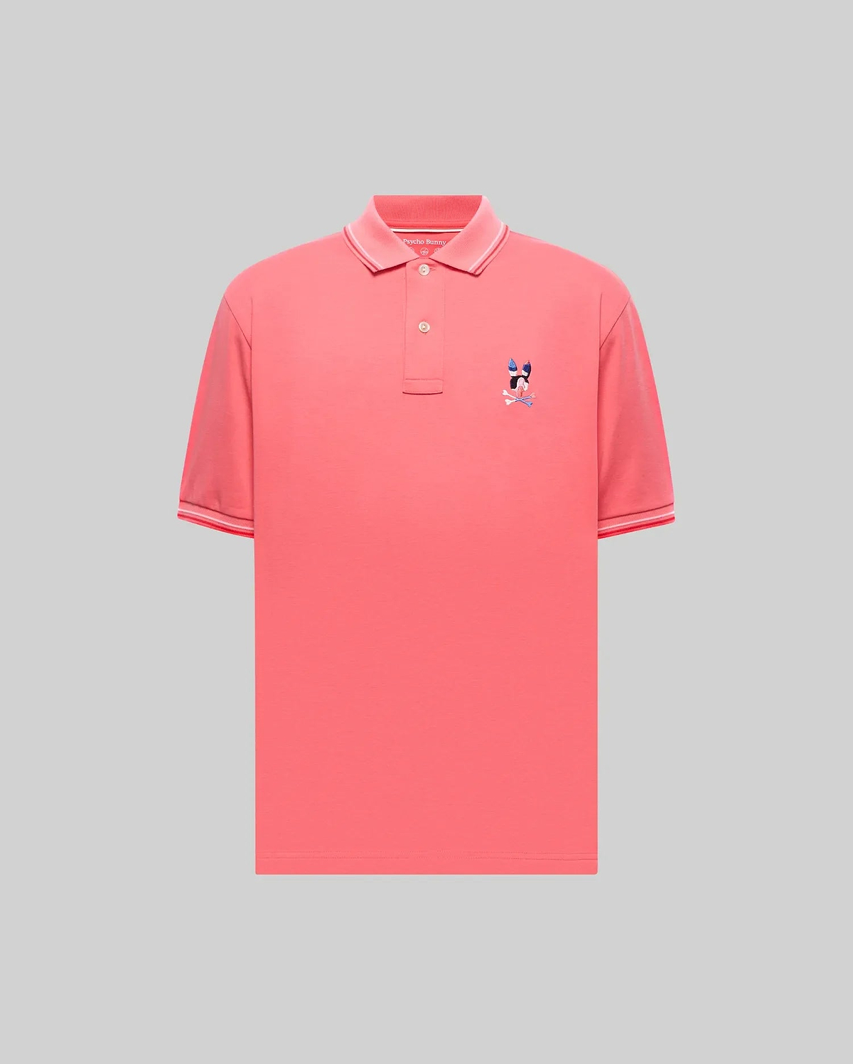 Mens Ara Pique Polo in vibrant coral pique, featuring a classic fit, ribbed collar and cuffs with white and red tipping, and a small embroidered multi-color Psycho Bunny skull logo on the left chest. (5)