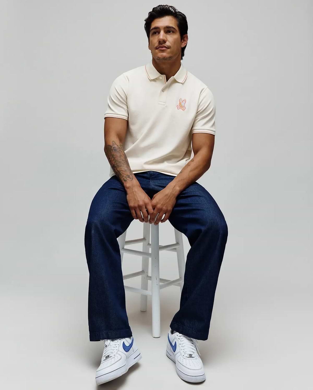 Mens Olivier Pique Polo, cream classic fit pique polo with orange tipping on collar and cuffs, featuring a small embroidered orange Psycho Bunny skull logo on the left chest. (1)