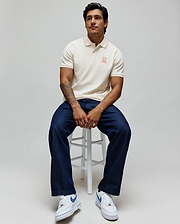 Mens Olivier Pique Polo, cream classic fit pique polo with orange tipping on collar and cuffs, featuring a small embroidered orange Psycho Bunny skull logo on the left chest. (1)