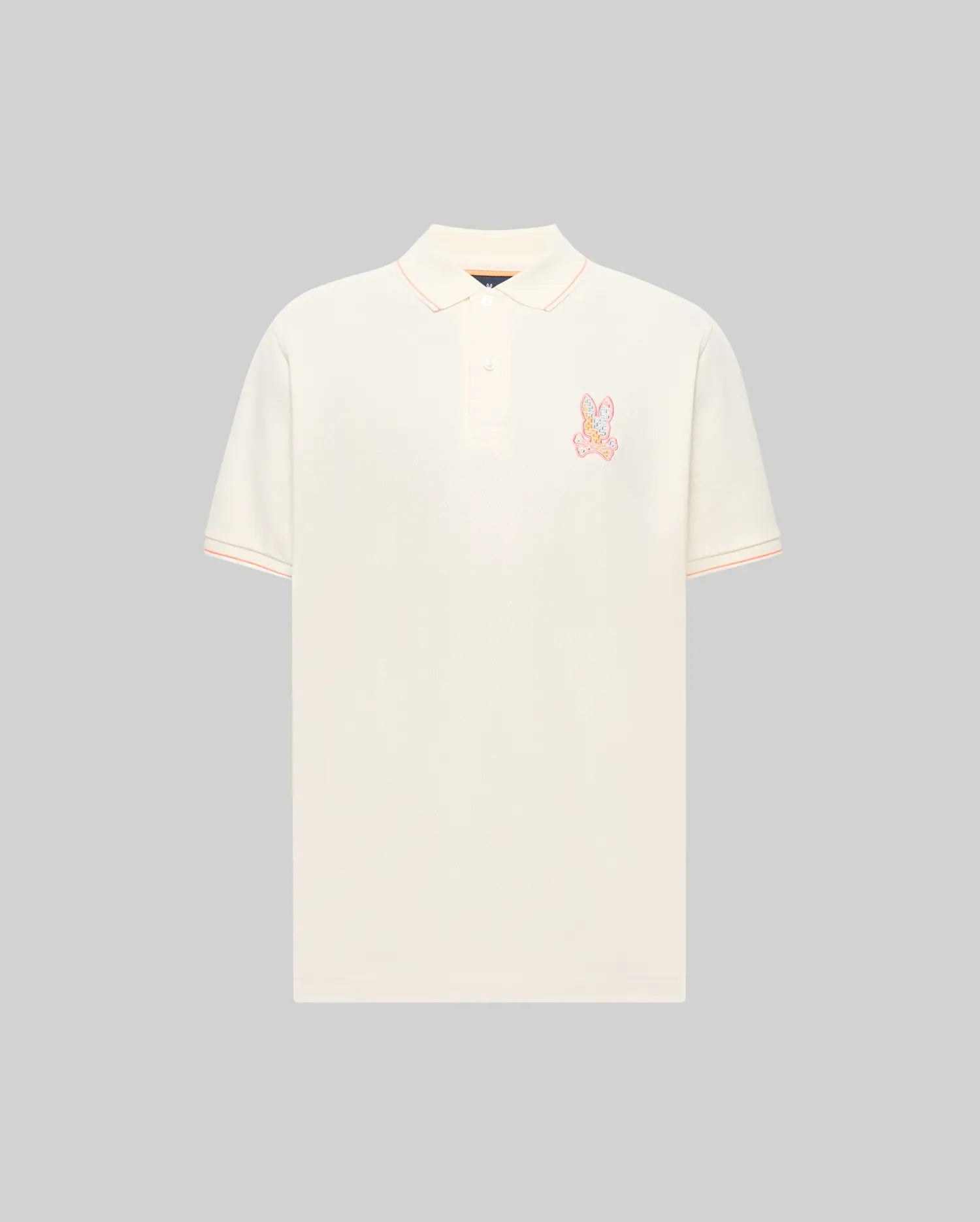 Mens Olivier Pique Polo, a classic fit cream pique polo with peach tipping on the collar and sleeve cuffs, featuring a vibrant multi-color embroidered Psycho Bunny skull logo on the left chest. (4)