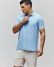 Mens Clark Pique Polo, sky blue classic fit pique knit with white and red striped collar and cuffs, featuring a small embroidered coral Psycho Bunny skull logo on the left chest and striped side vents. (1)