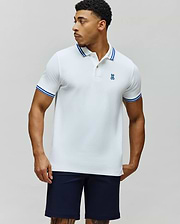 Mens Clark Pique Polo, a classic fit white pique polo with blue tipped collar and cuffs, featuring a small embroidered blue Psycho Bunny skull logo on the left chest. (3)