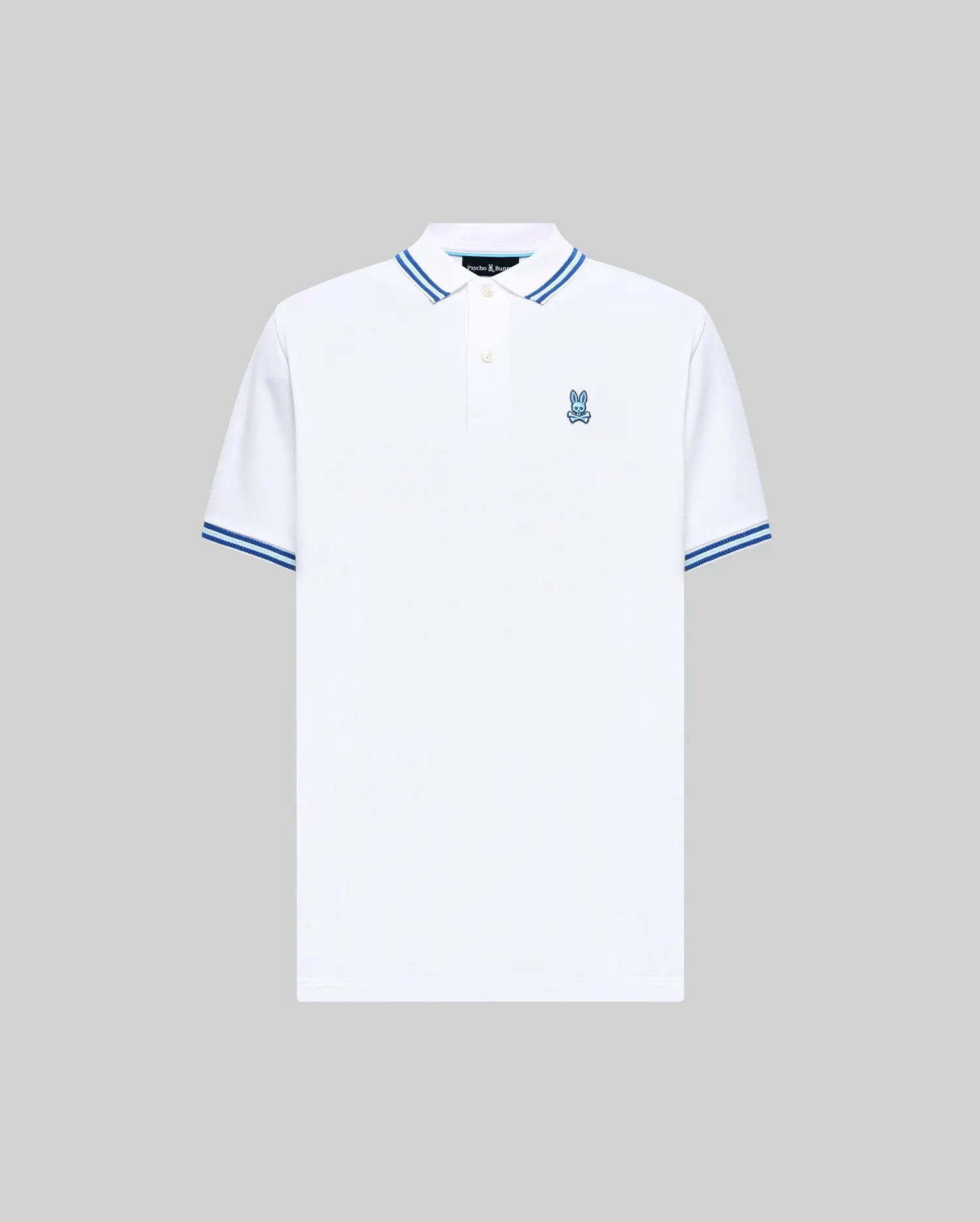 Mens Clark Pique Polo, a classic fit white pique polo with blue striped collar and cuffs, featuring a small blue embroidered Psycho Bunny skull logo on the left chest. (5)