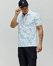 Mens Nev Sport Polo in white jersey knit, featuring an all-over pattern of small blue Psycho Bunny skull logos, with a classic fit and white collar and cuffs.
