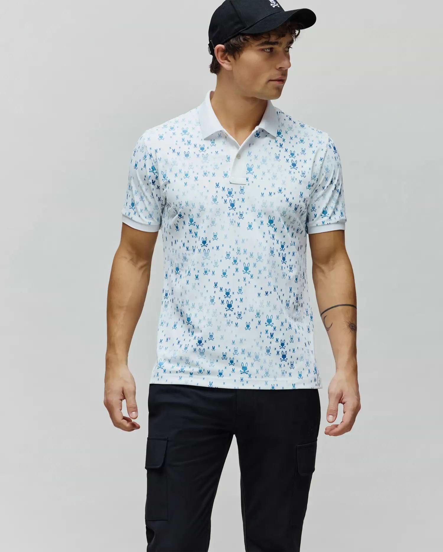 Mens Nev Sport Polo, white premium performance jersey with an all-over gradient blue iconic Psycho Bunny skull logo print, classic fit, white collar and cuffs.