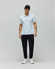 Mens Nev Sport Polo, white pique knit with an all-over light blue Psycho Bunny skull print, classic fit, featuring a small embroidered bunny logo on the left chest and ribbed collar/cuffs.