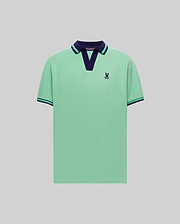 Mens Christiano Pique Polo in mint green pique with a navy V-neck collar featuring a green stripe, matching striped ribbed cuffs, and a small embroidered navy Psycho Bunny skull logo on the left chest. (4)
