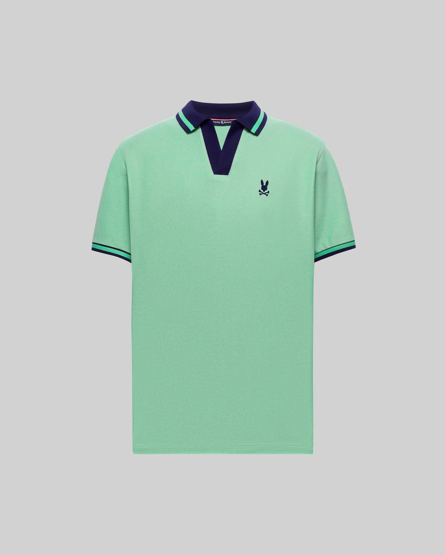 Mens Christiano Pique Polo in mint green pique with a navy V-neck collar featuring a green stripe, matching striped ribbed cuffs, and a small embroidered navy Psycho Bunny skull logo on the left chest. (4)