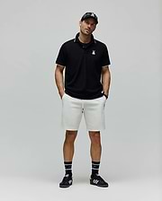 Black Mens Aram Pique Polo with white tipping on the collar and cuffs, featuring a small white embroidered Psycho Bunny skull logo on the left chest, in a classic fit. (4)
