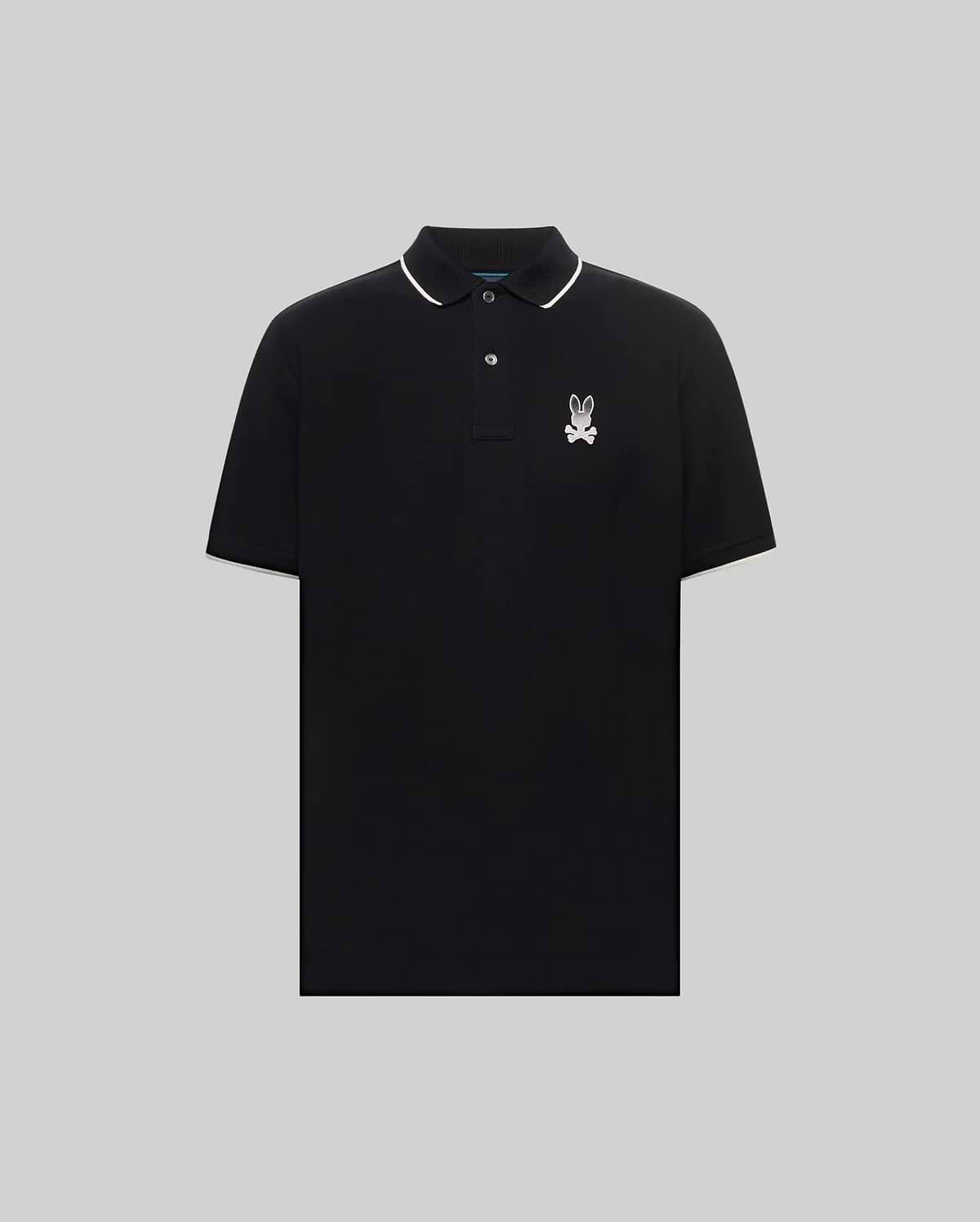 Mens Aram Pique Polo, a classic fit black pique polo with white tipping on the collar and sleeve cuffs, featuring an embroidered white Psycho Bunny skull logo on the left chest. (5)