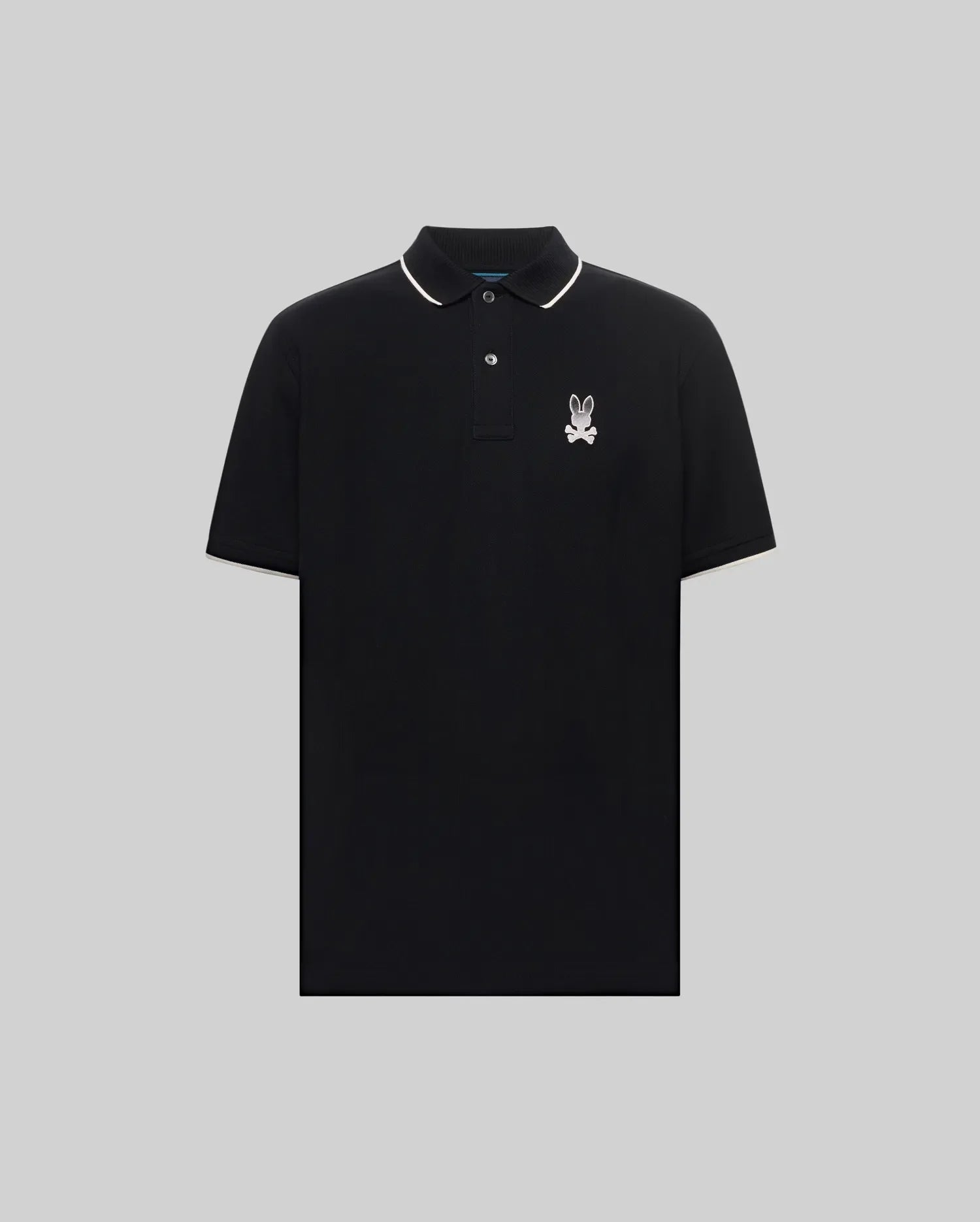 Mens Aram Pique Polo, a classic fit black pique polo with white tipping on the collar and sleeve cuffs, featuring an embroidered white Psycho Bunny skull logo on the left chest. (5)